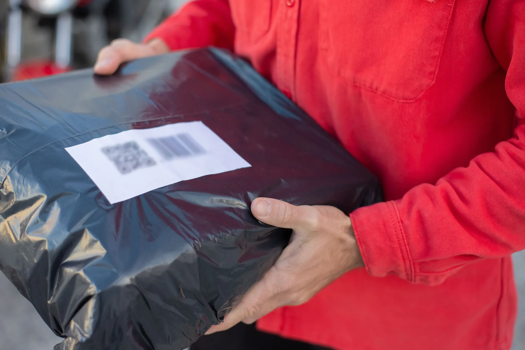 Close view of a parcel being prepared for movement through an ecommerce operation.
